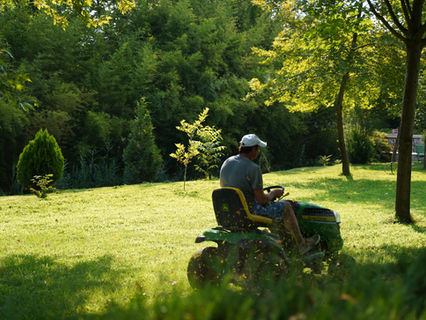 Man sat on ride on lawn mower.jpg