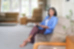 Edith Parinas, The Mortgage Broker for first time buyers, women and self-employed people. Sitting on couch