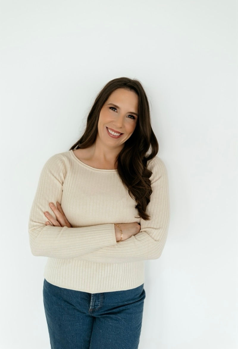 Female with long brown straight hair smiling at the camera