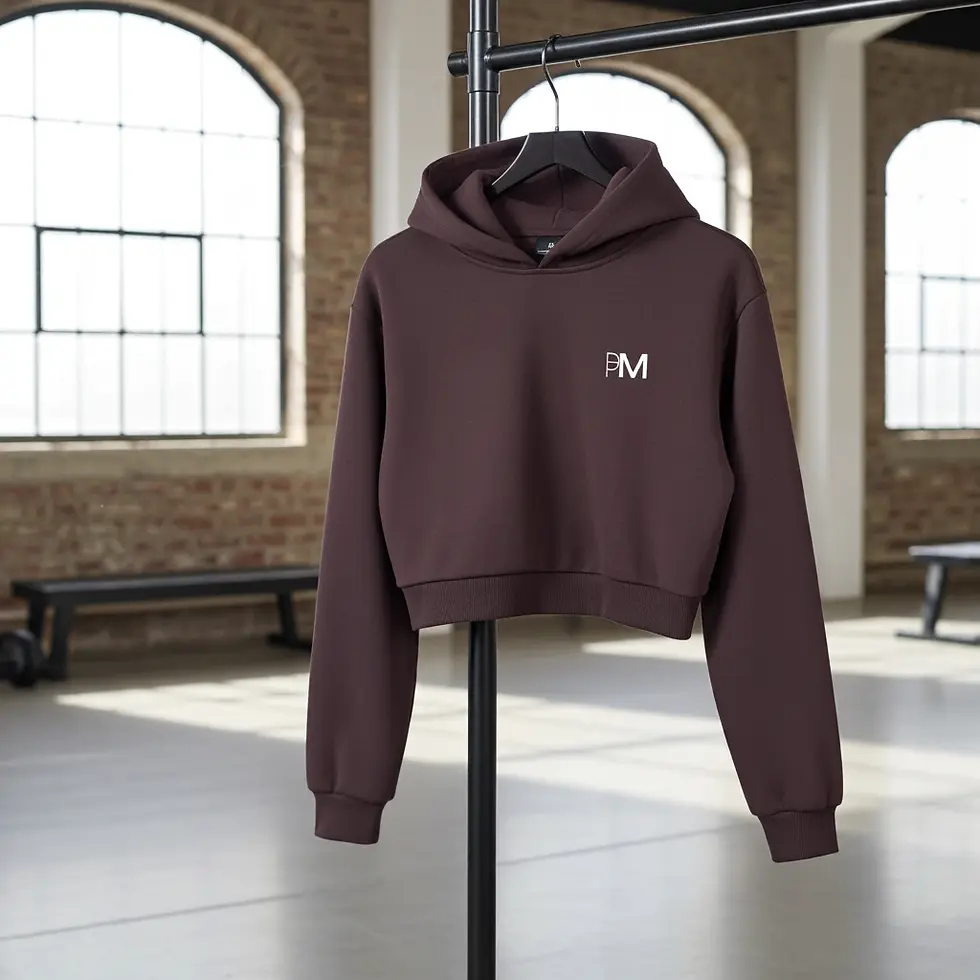 Brown hoodie with PM logo, hanging on a black pipe, gym wear, Protein Mama Gym Wear