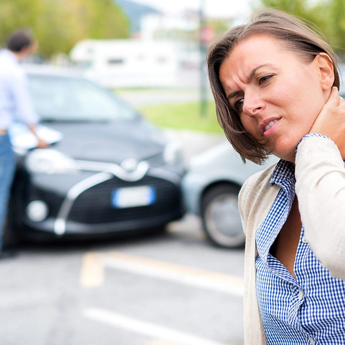 A woman holding her neck from a car accident whiplash