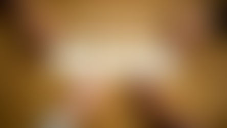 Hands on a wooden table arranging smiley cards under the word "Feedback." 