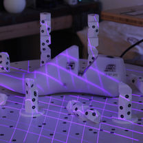 White shoe model with purple scanning lasers with reference dots around 