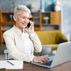 A senior businesswoman calls customer service to check on a spam email