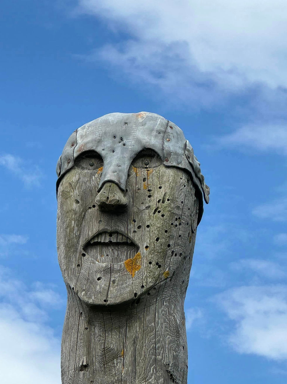 Wooden sculpture with metal helmet on Orkney Islands