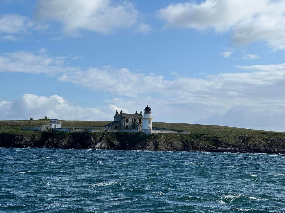 A lighthouse on a rugged cliff in the Hebrides
