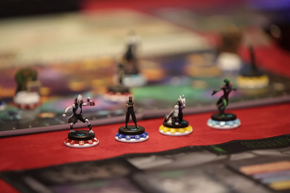Four character miniatures on coloured HP tracking bases