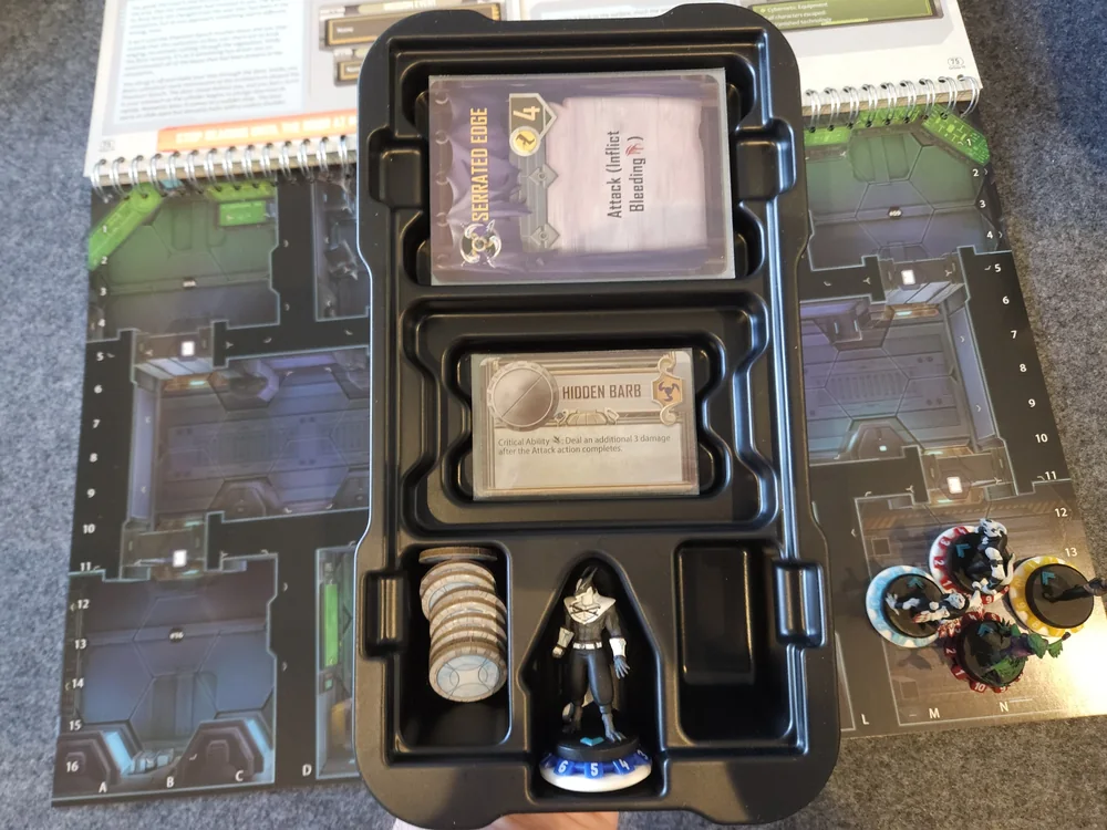 A character save tray holds Action cards, equipment, tokens and a miniature