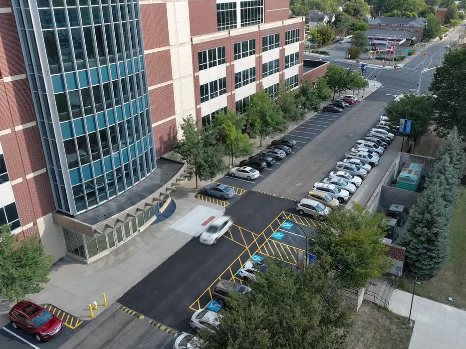 Aerial view of parking lot reconstruction at the University of Akron. There are cars parked in the lot.