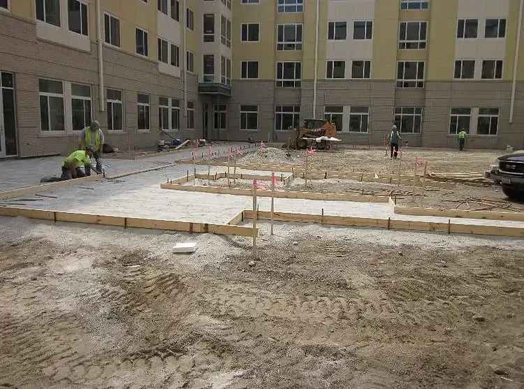 Student housing building being actively worked on by construction personnel.