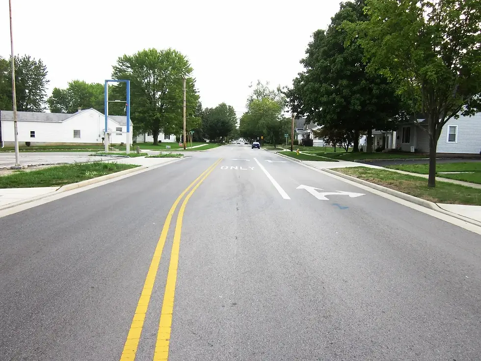 Two-way road with painted traffic markings. 