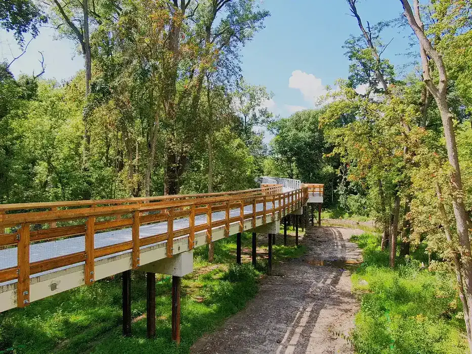 Connector trail at Swan Creek Park. There are trees in the background.