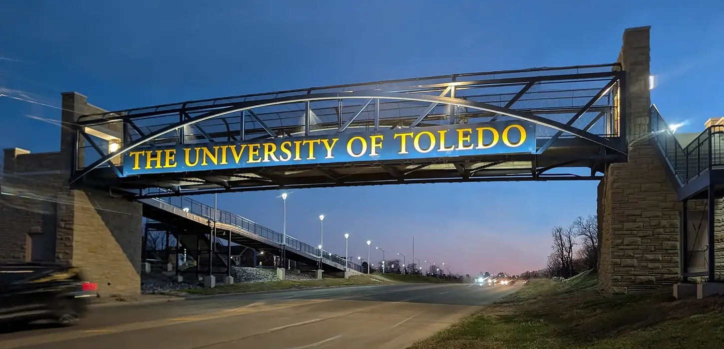 Pedestrian bridge at the University of Toledo featuring gothic stone to match architecture that is noticeable throughout the campus.