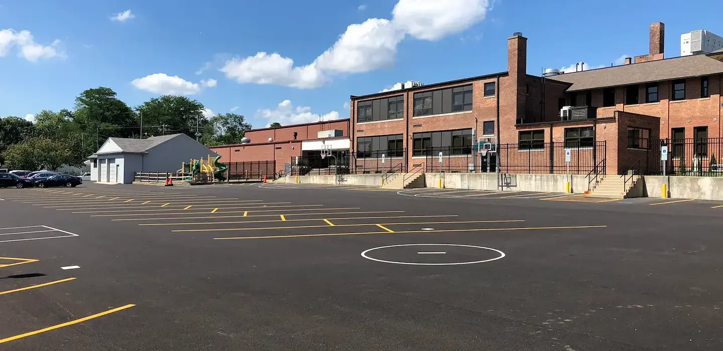 Asphalt parking lot with freshly painted parking spots. 