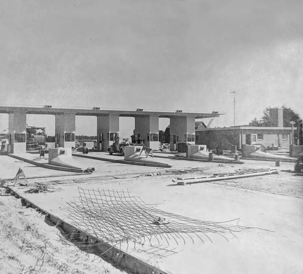 Historic black and white photo of a Turnpike Toll Plaza under Construction.