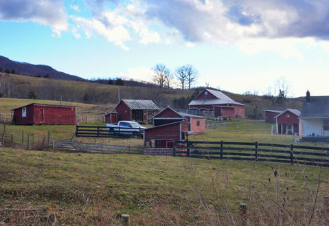 A group of red barns and buildings. The name is what my Dad used to call this place as a child.