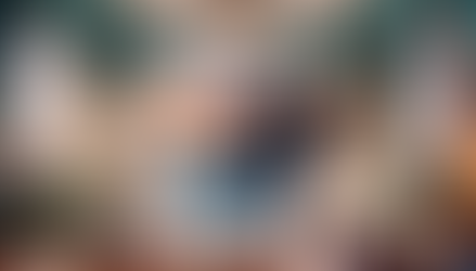 A smiling robot in a colorful room wearing a plaid shirt and jeans, surrounded by clothes and shoes—symbolizing personalization and automation through CRM Customization. Bright atmosphere with framed art.