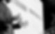 A picture of a man's hand's with a clicker talking into a microphone