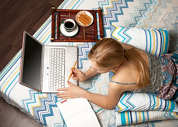 Woman on laptop in bed