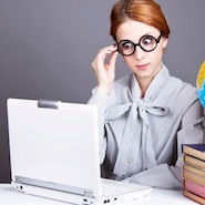 Woman in glasses looking at laptop screen