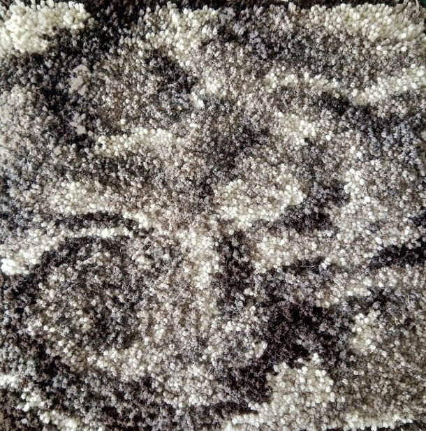 Thumbnail: Detail of black, white and grey knotted rug sample