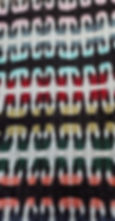 Back view of multicoloured handwoven lap rug showing a hook pattern