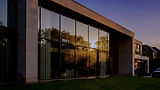 Nano_Banana_Pro_A_modern_luxury_home_with_large_glass_windows_and_polished_stone_exterior_