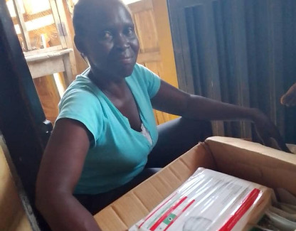 A woman with a box full of medical supplies.