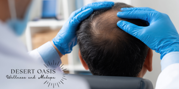 Gloved clinician examines a man’s thinning scalp in a clinic, with Desert Oasis Wellness and Medspa logo visible.