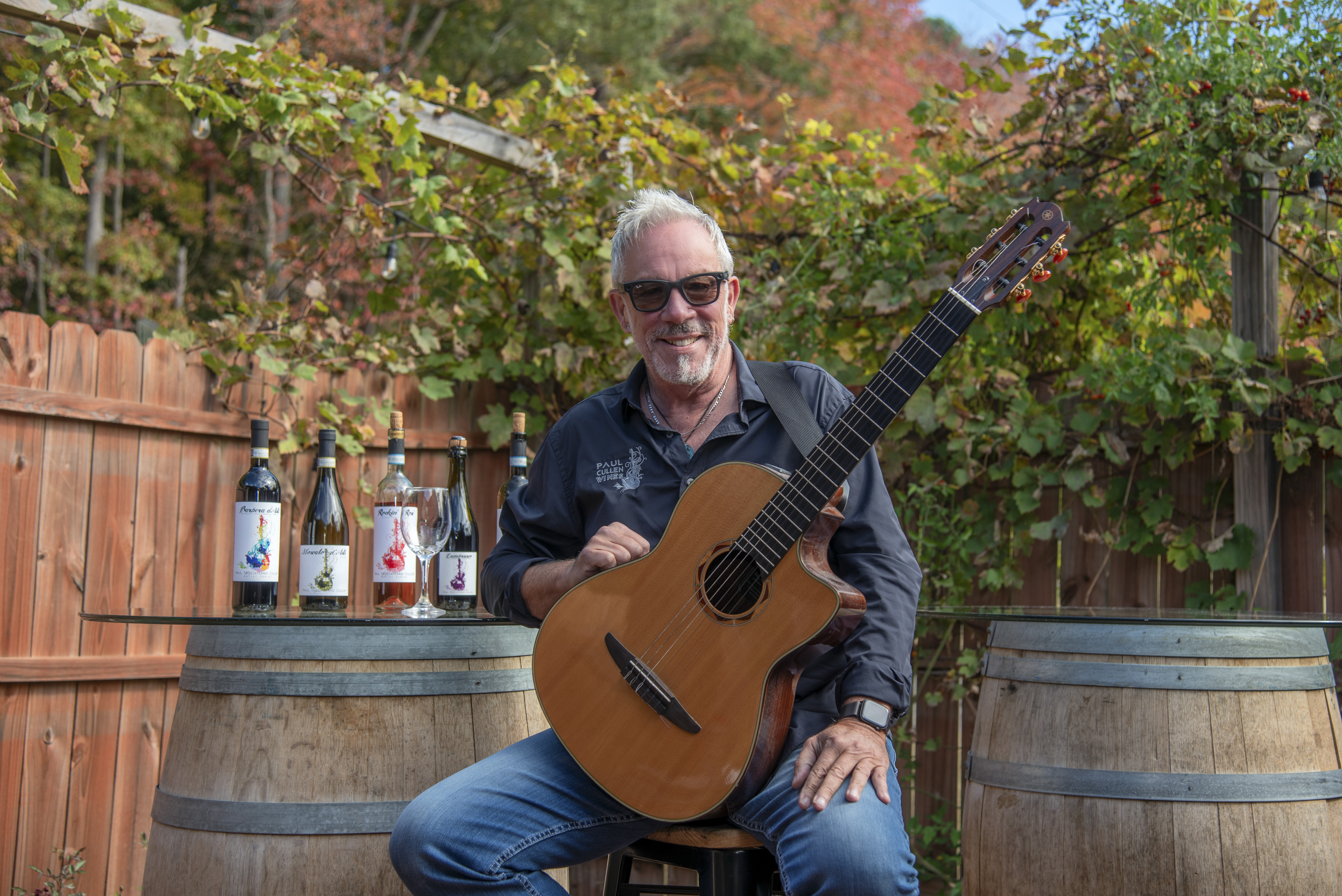 Paul Cullen with his guitar and wines