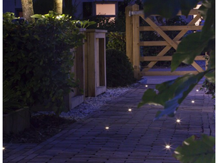 Professionally installed outdoor lighting illuminating a modern North Idaho home at dusk.
