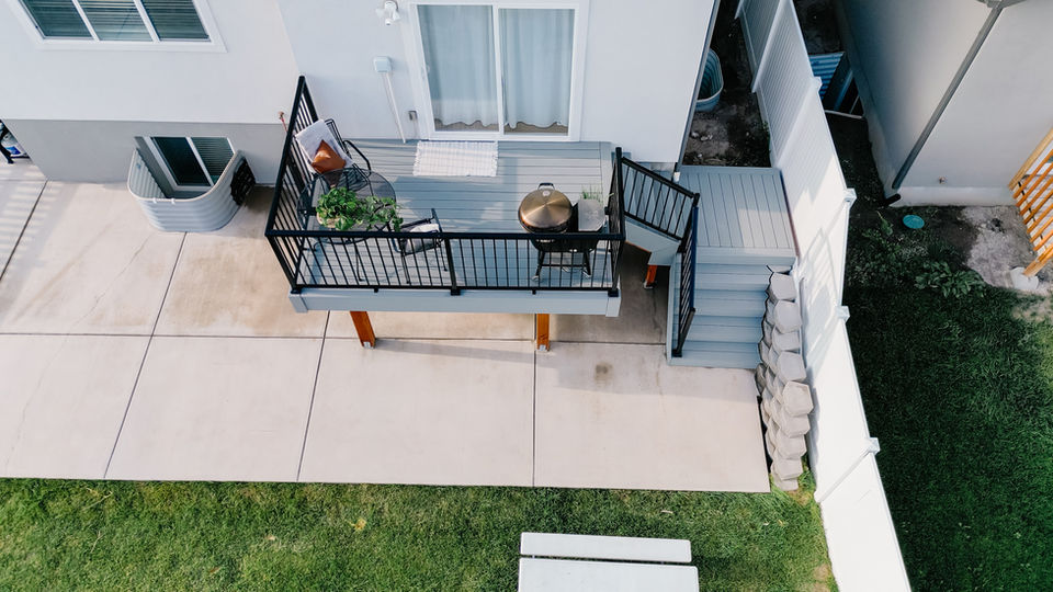 Walking out your back door onto your new deck that flows down to your leveled backyard in Post Falls, Idaho