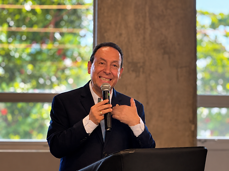 Smiling Speaker at the Podium.png