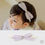 Thumbnail: Introducing the Ellis Baby Hairband, a charming accessory featuring a lovely purple check ribbon adorned with a gold ribbon c