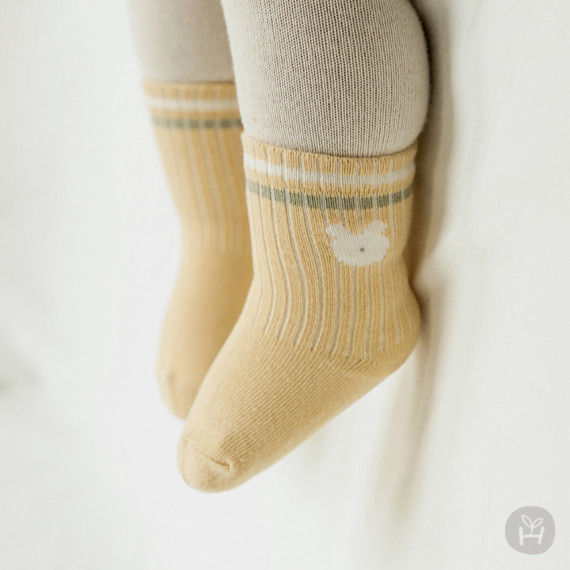 The Nio Baby Knee Socks are adorable accessories featuring cute rabbit and teddy bear motifs. With color-coordinated lines fo