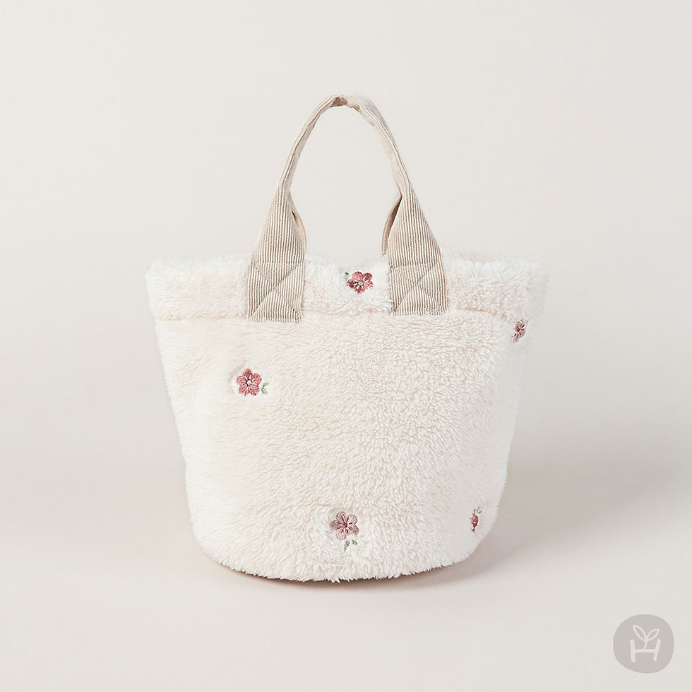 The Barsha Picnic Bag is a lightweight and cozy accessory designed with lovely floral embroidery on fluffy fur material.