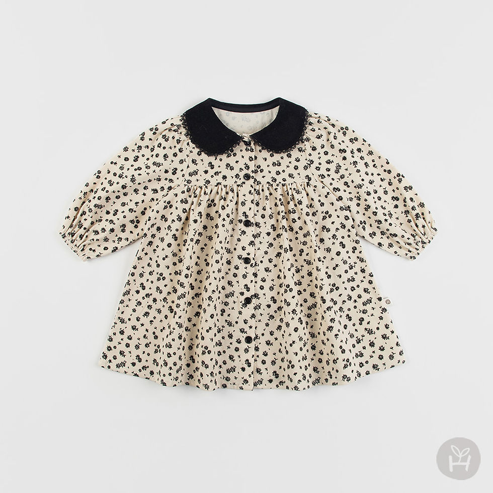 The Yvonne Corduroy Baby Dress features a lovely silhouette with a comfortable A-line fit, complemented by a front button clo