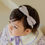 Thumbnail: Introducing the Ellis Baby Hairband, a charming accessory featuring a lovely purple check ribbon adorned with a gold ribbon c