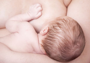 Close-up of a newborn baby breastfeeding.jpg