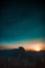 Sunset and starry sky over a rocky mountain range