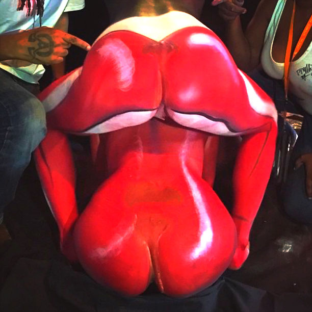 The Rolling Stones lips body painted on the butts of two women. 