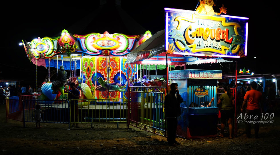 a carnival with a sign that says tickets