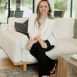 Woman in white blazer on sofa for Move Smart Strategy Session