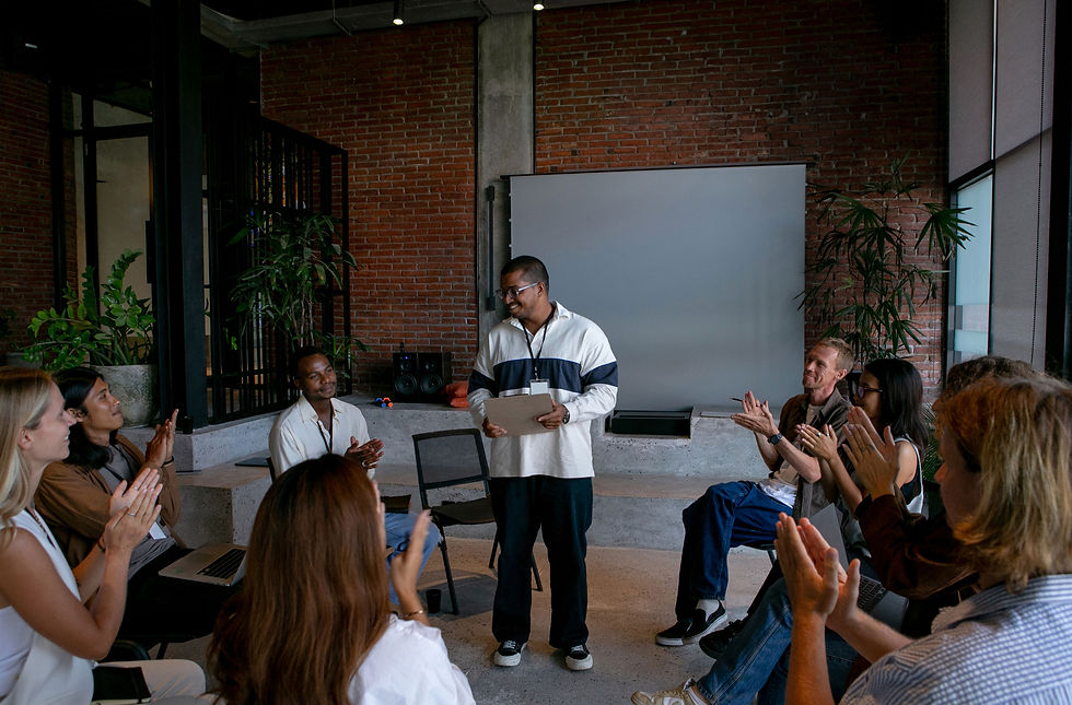 A workshop where a participant is standing in a circle of other participants