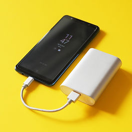a mobile phone connected to a power bank