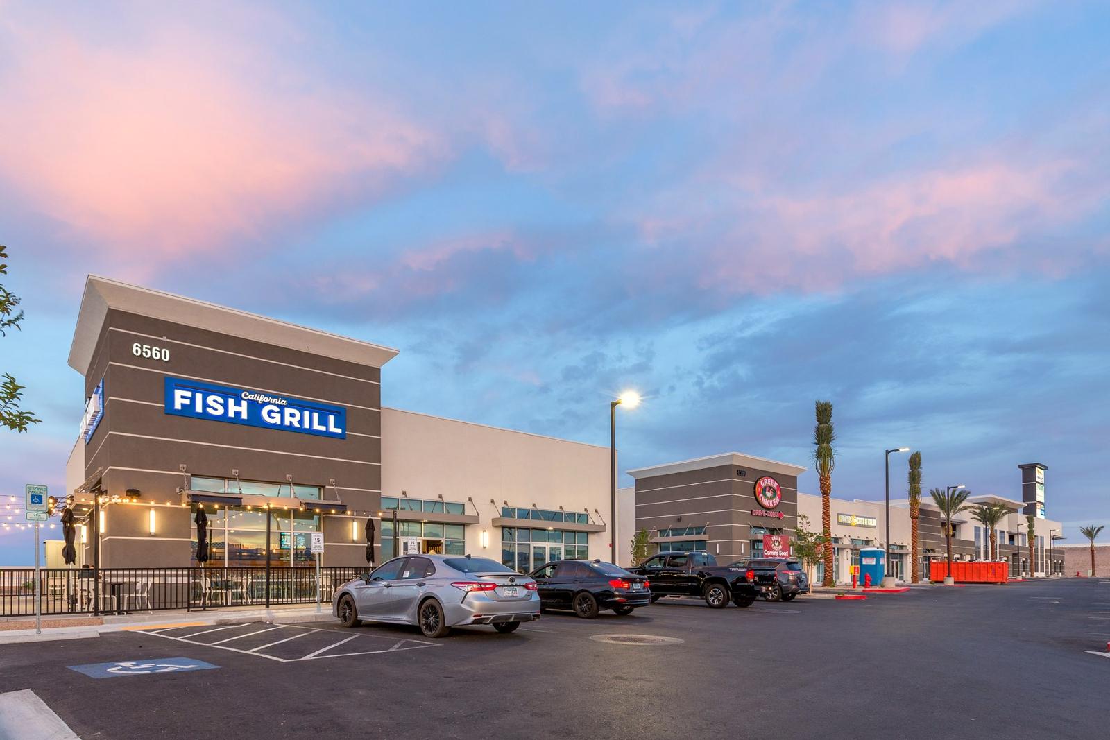 Rainbow Commons multi-tenant retail center at dusk, ground-up commercial construction, Las Vegas