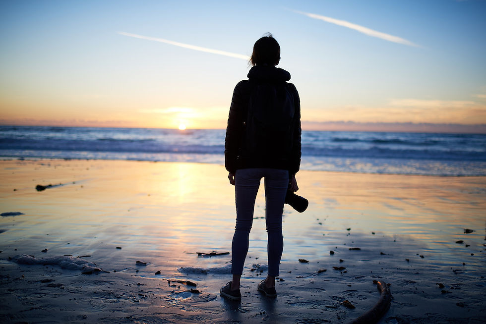 Peaceful person look at the sun on the beach.