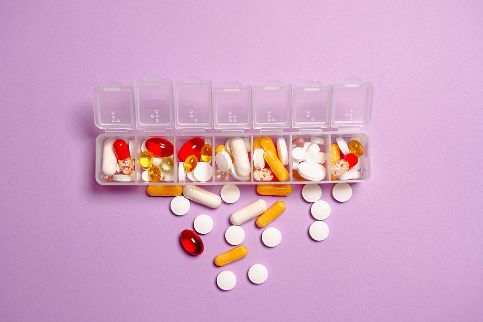 picture of weekly pill organizer opened up with pills coming out.