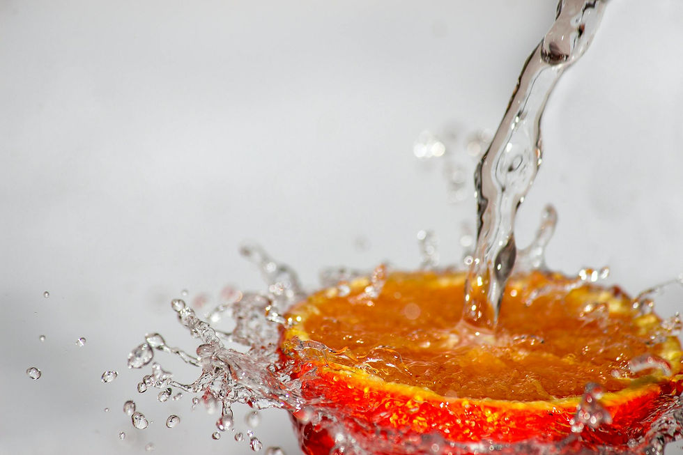 water pouring continuously over an orange slice