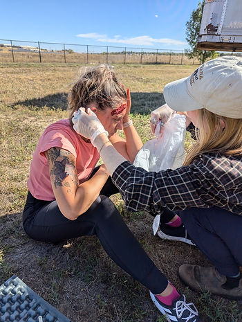 Student treats simulated injury on recent WFR course